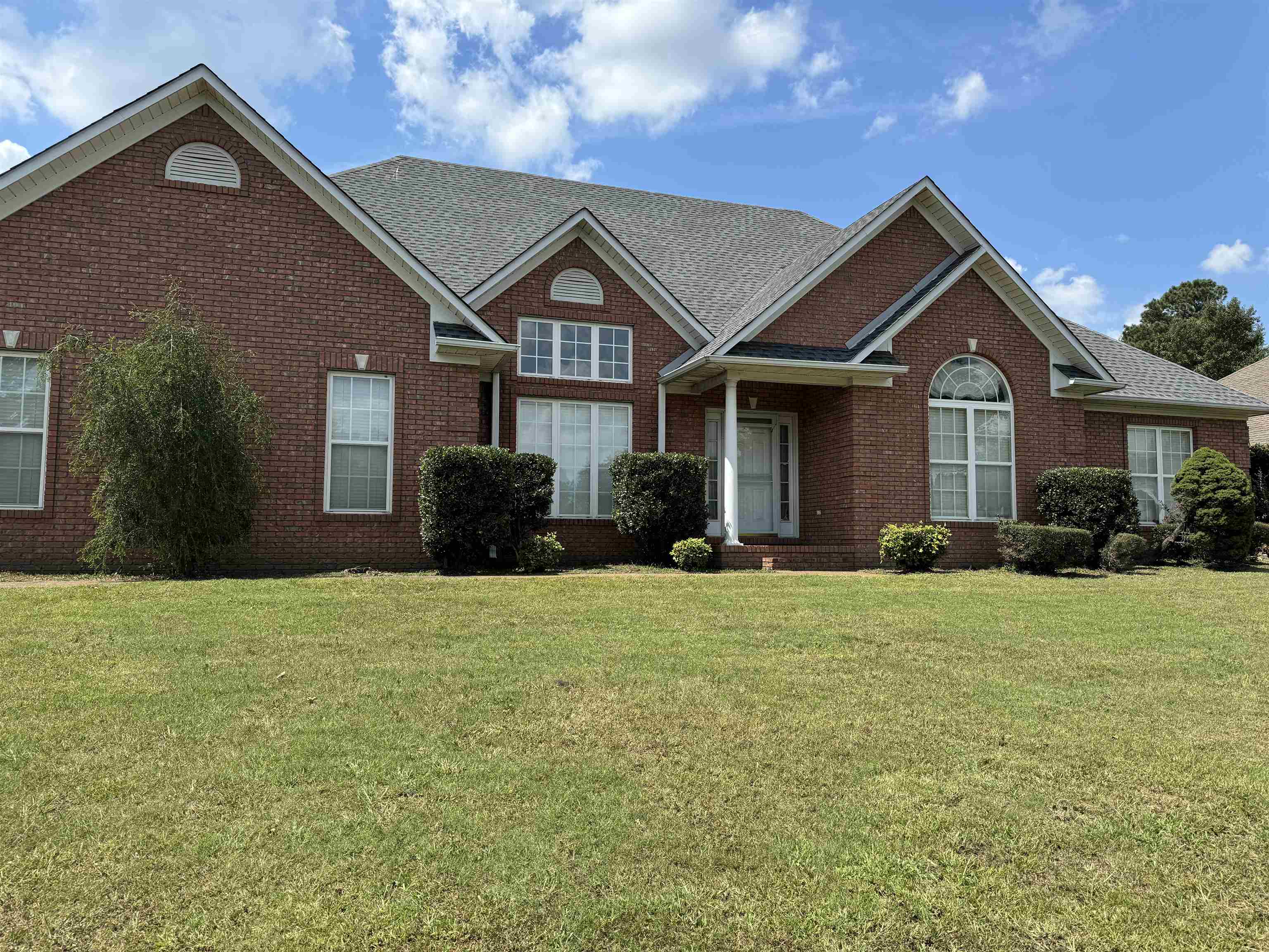 a front view of a house with a yard and garage