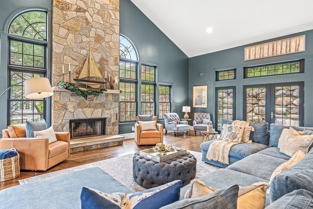 a living room with furniture a fireplace and a large window