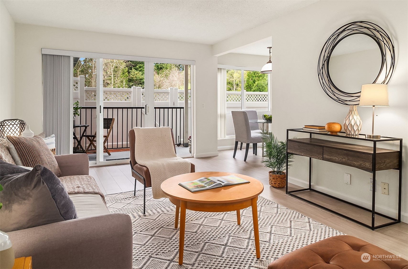 a living room with furniture a table and a large window