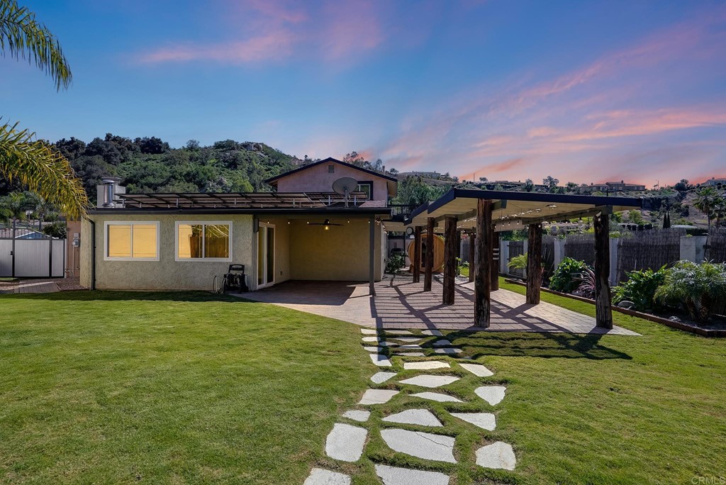 a view of a house with backyard porch and sitting area