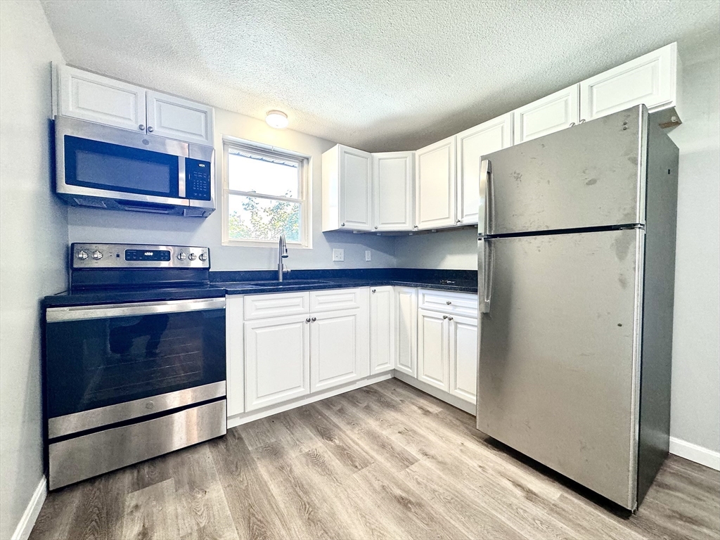 a kitchen with stainless steel appliances a refrigerator stove and sink