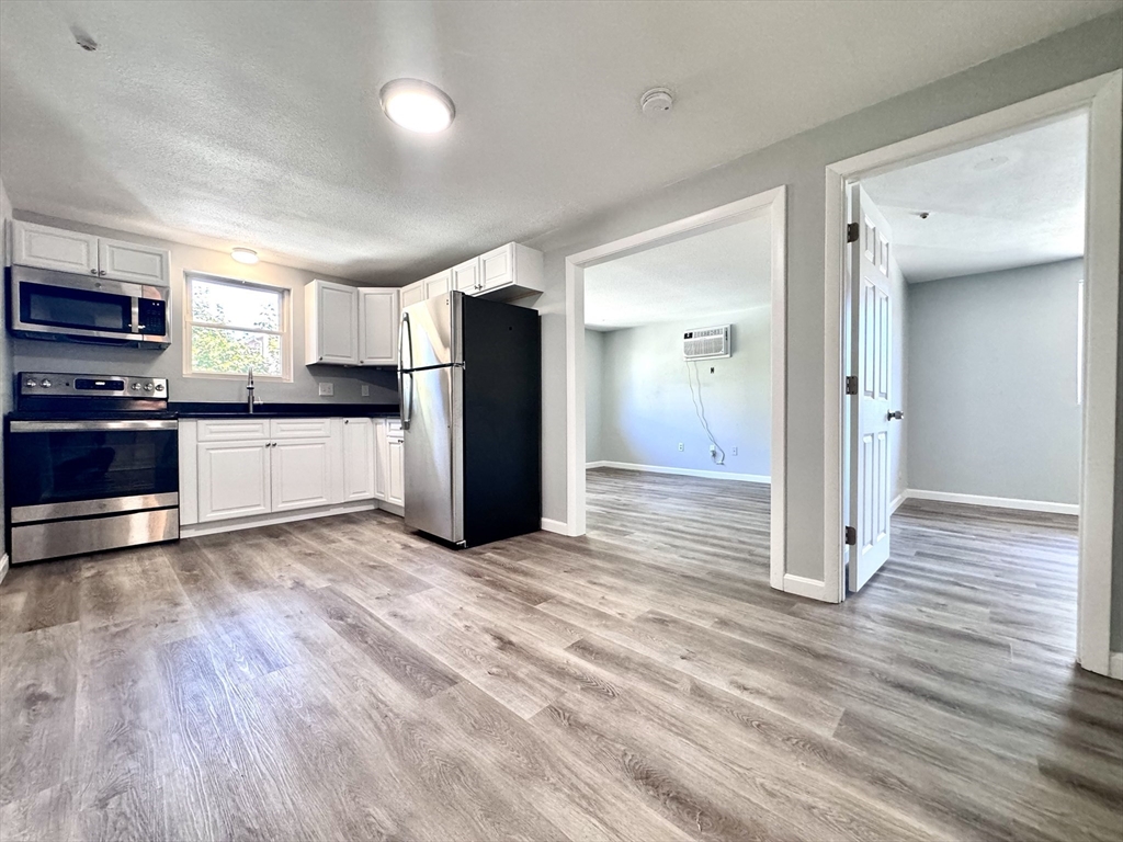 a view of a kitchen with electric appliances