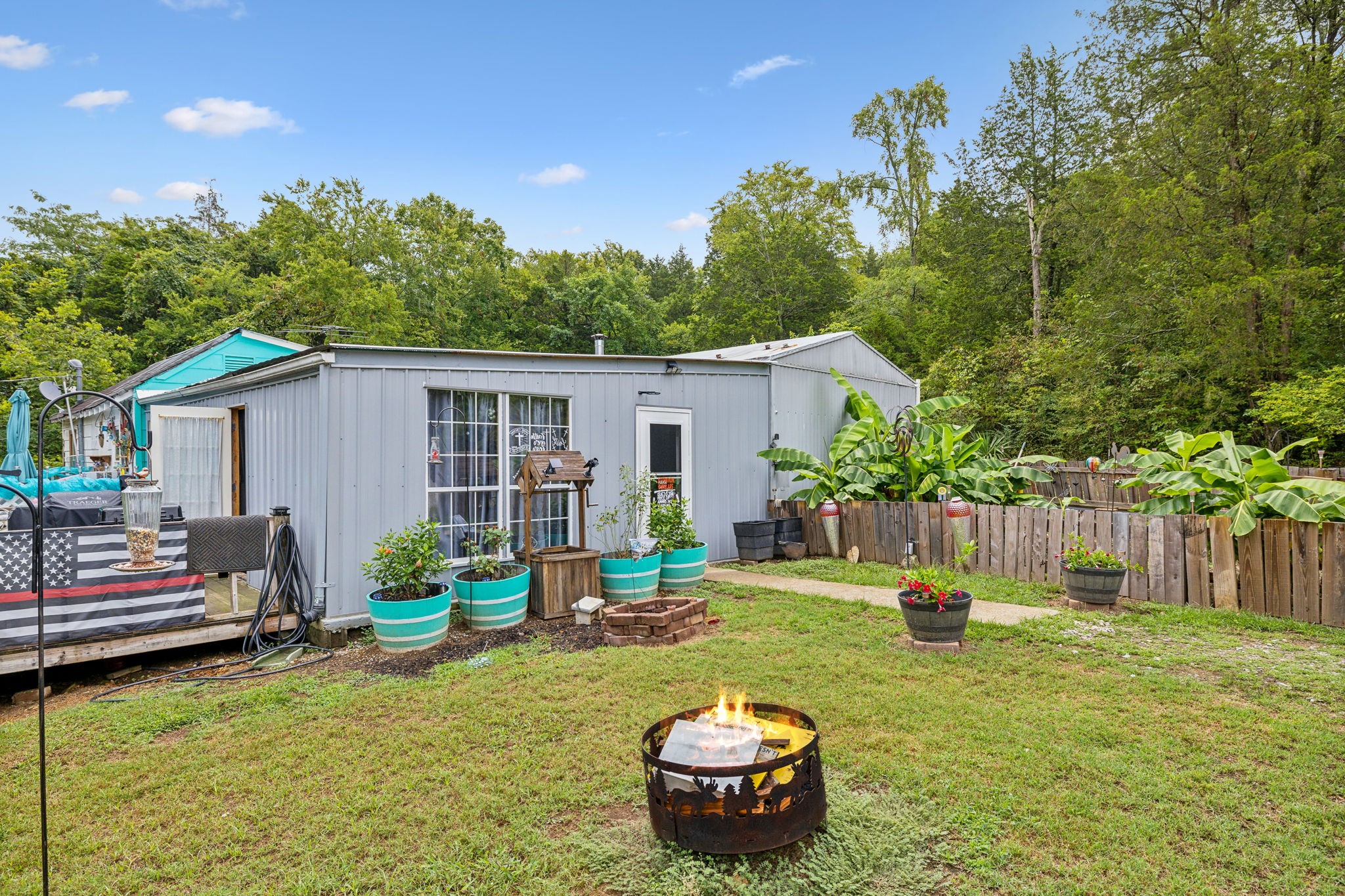 a view of a house with backyard and sitting area