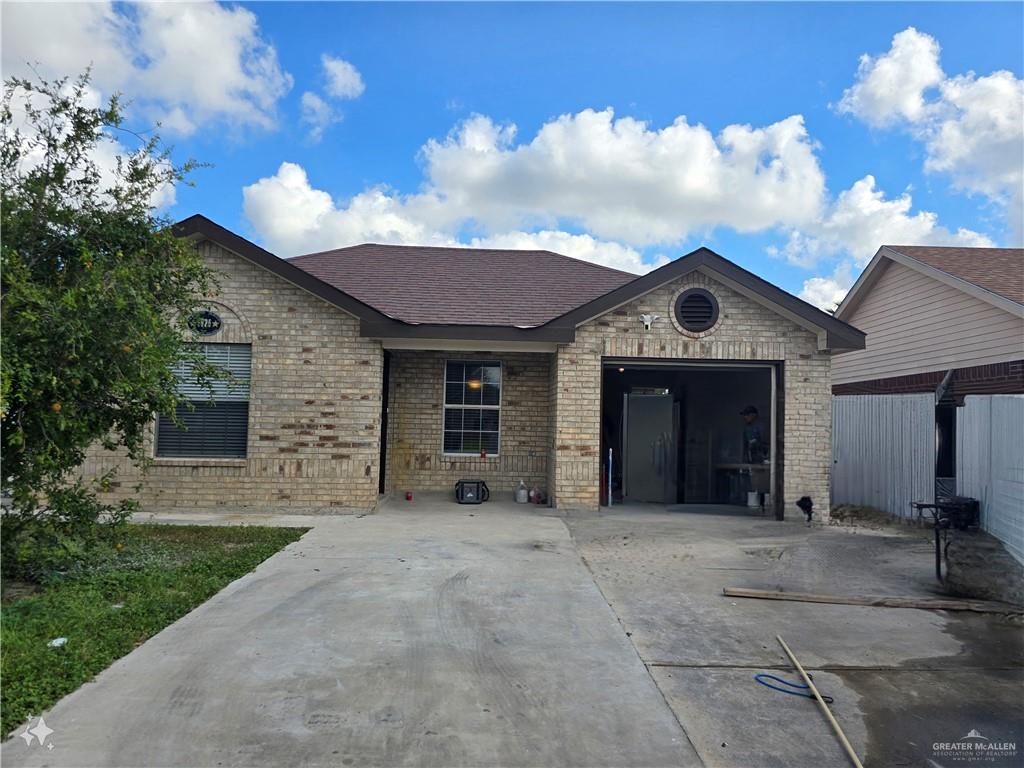 a view of a house with a yard and garage