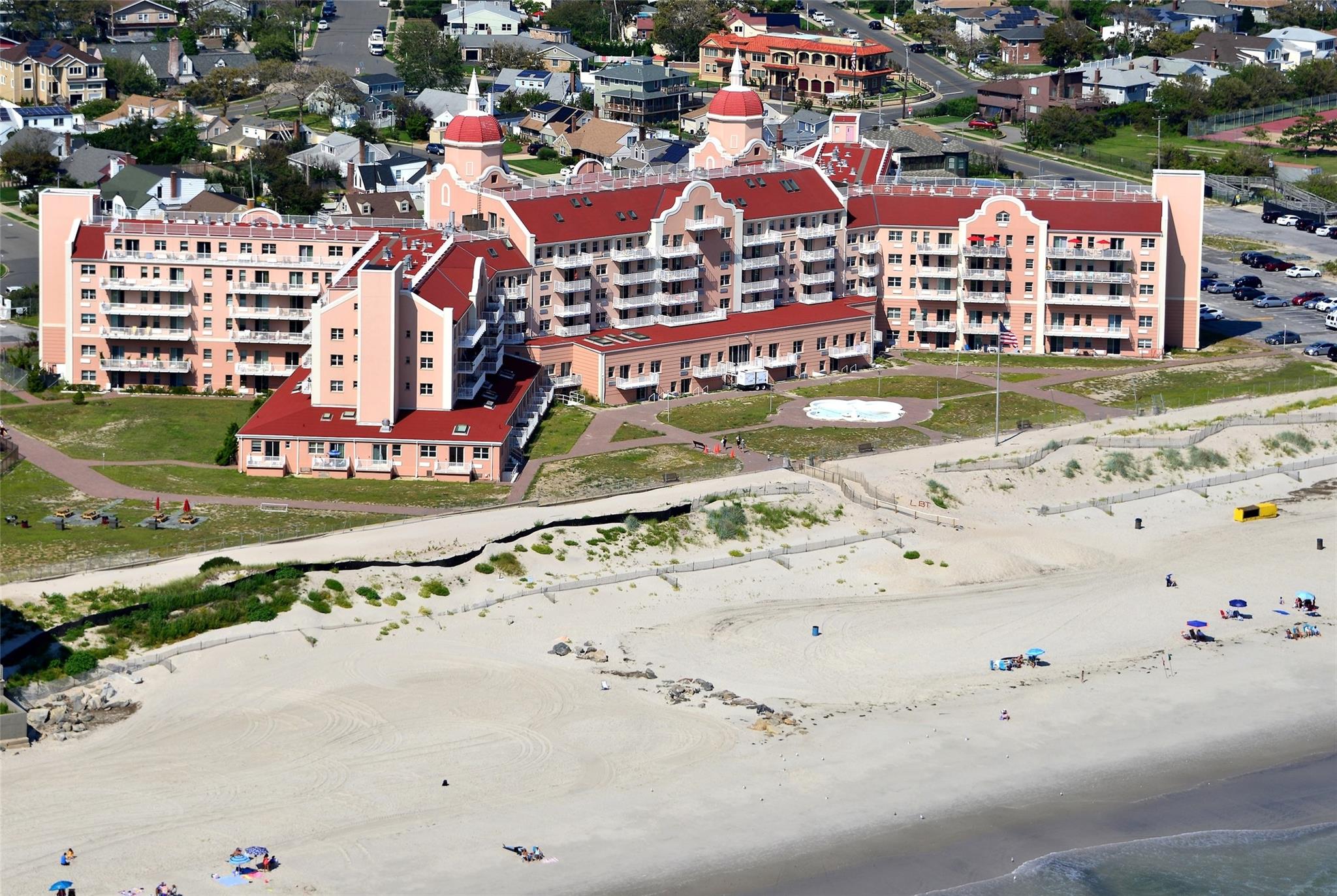 a large building with a couple of cars parked in front of it