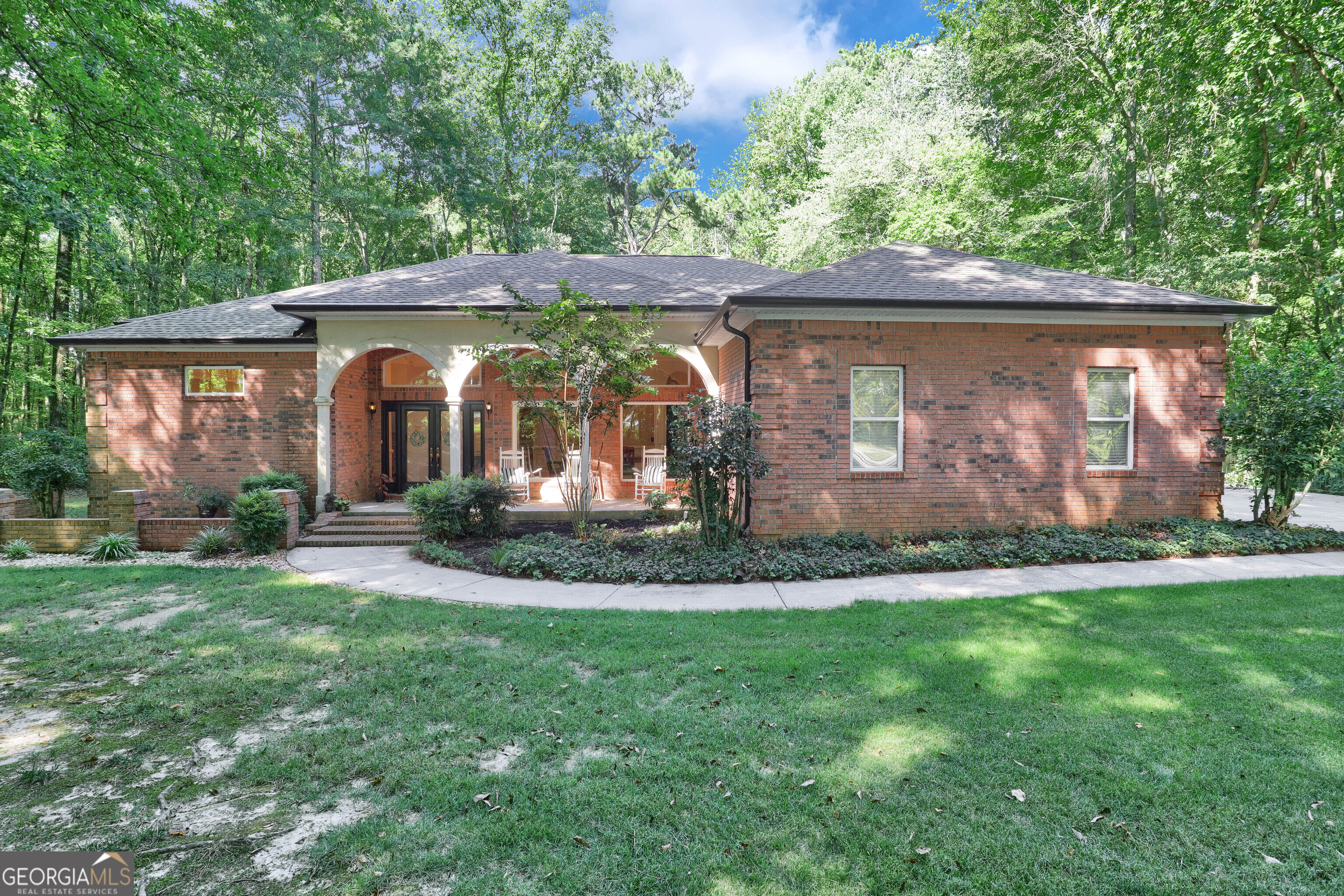 a front view of a house with a garden