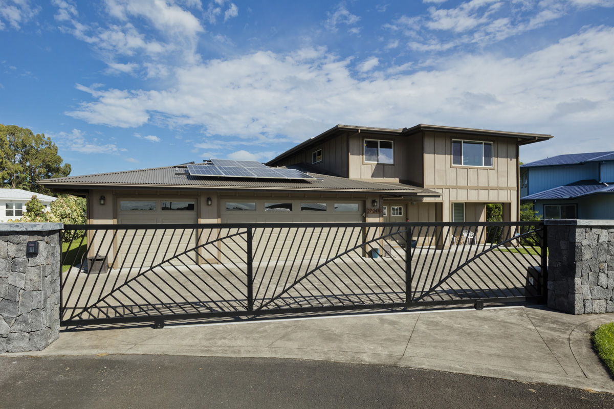 New custom electric entry gate and new front rock wall, Note some of the PV panels.