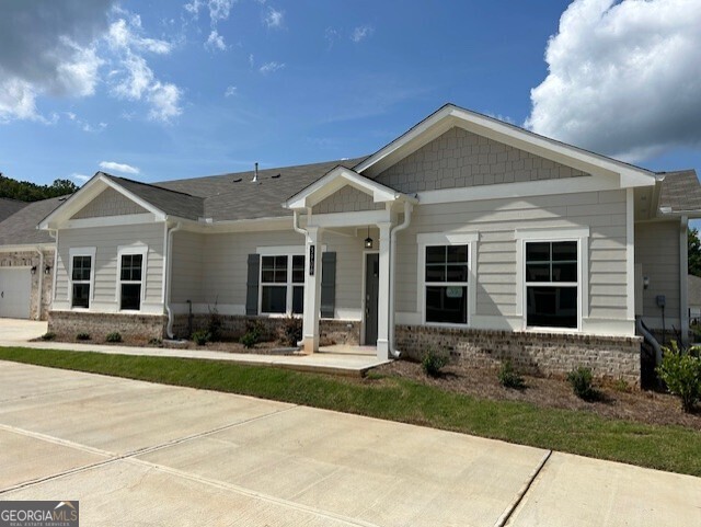 a front view of a house with yard and green space