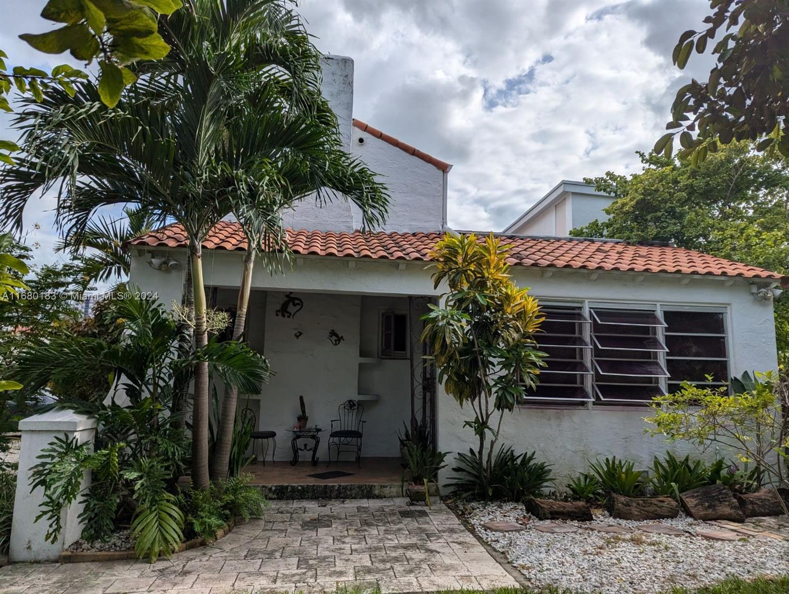 a front view of a house with garden