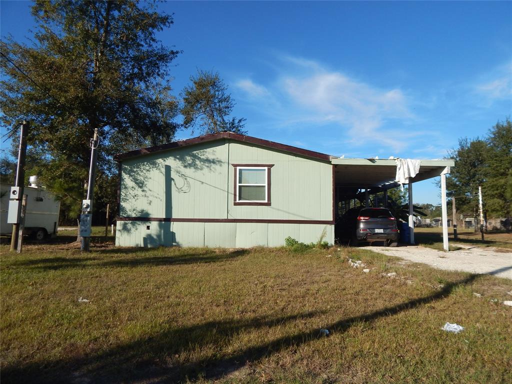 a view of a house with backyard porch and sitting area