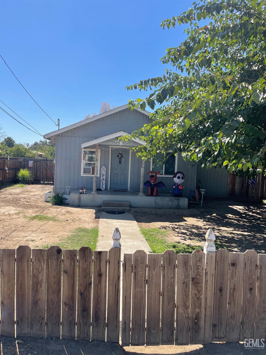 a view of a house with wooden fence