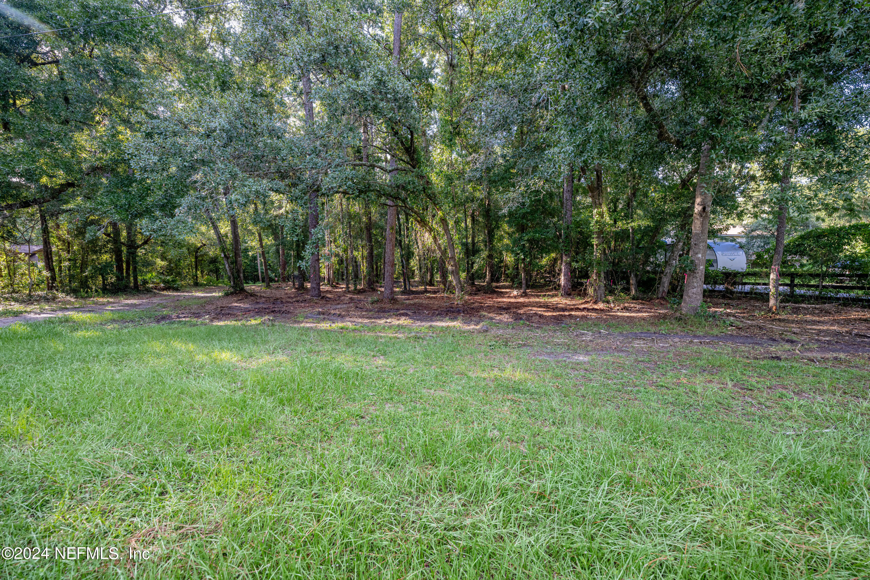 a view of outdoor space with trees all around