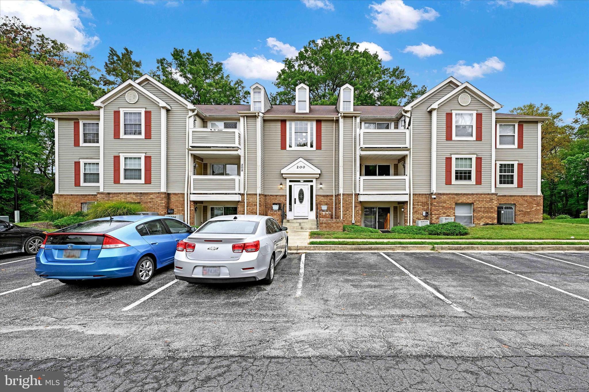 a front view of a residential apartment building with a yard