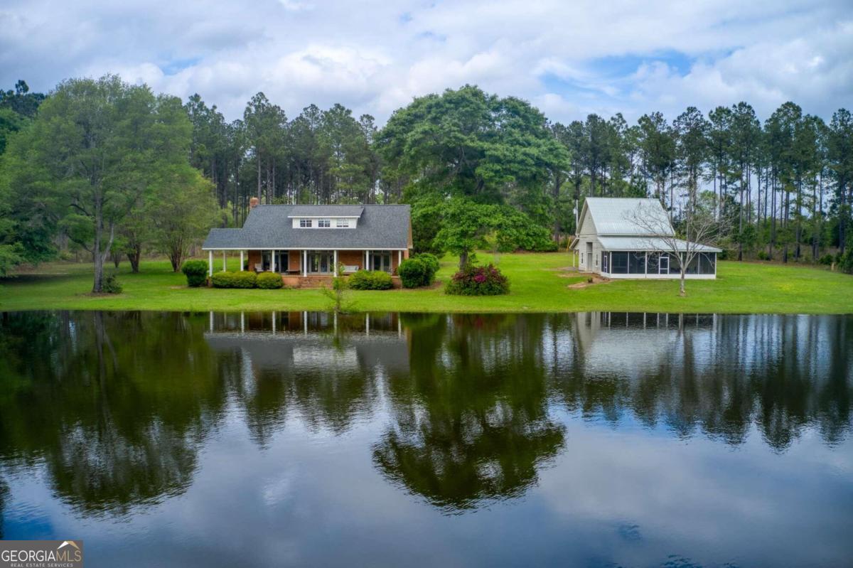 a view of a lake with a house in the background