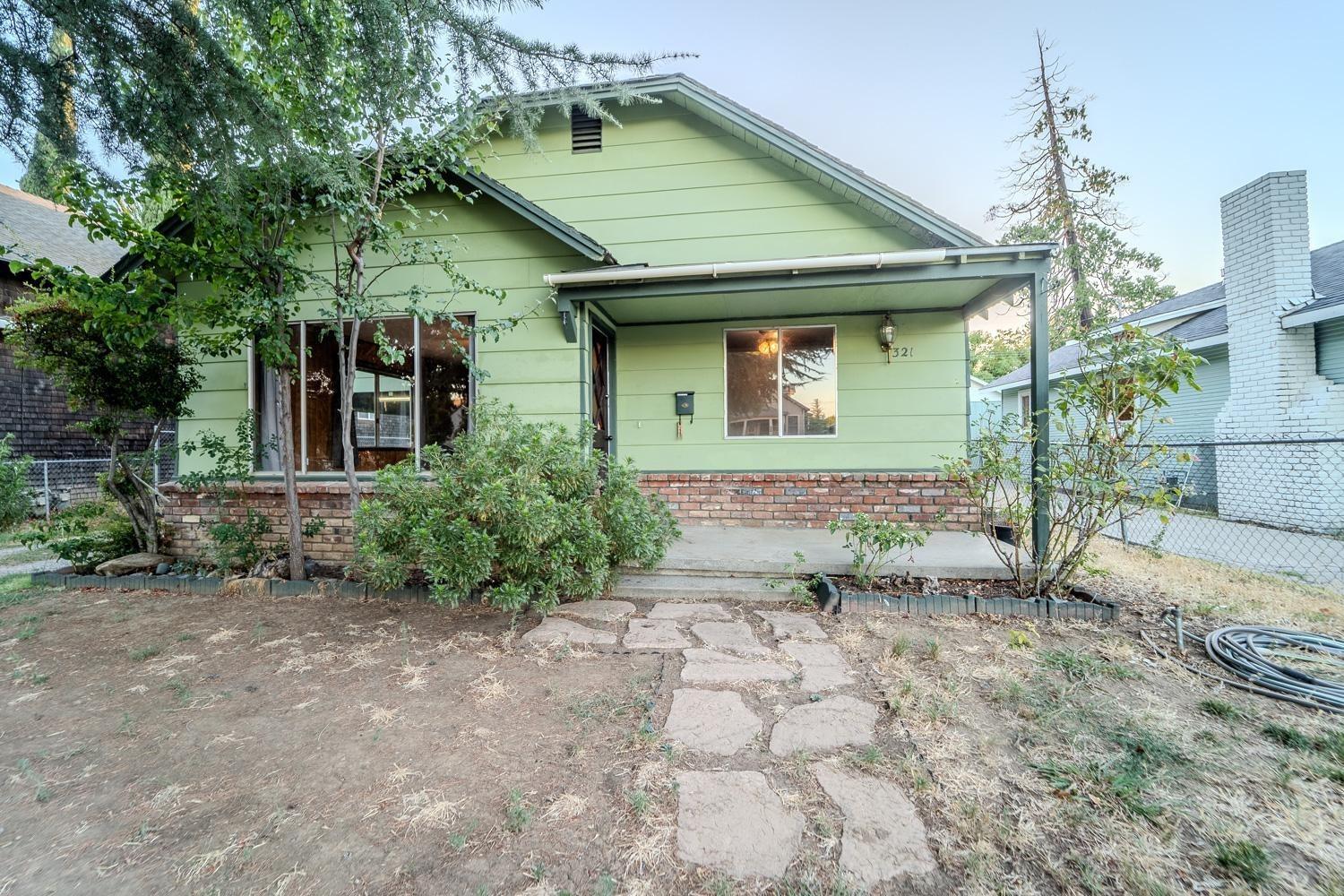 a front view of a house with garden