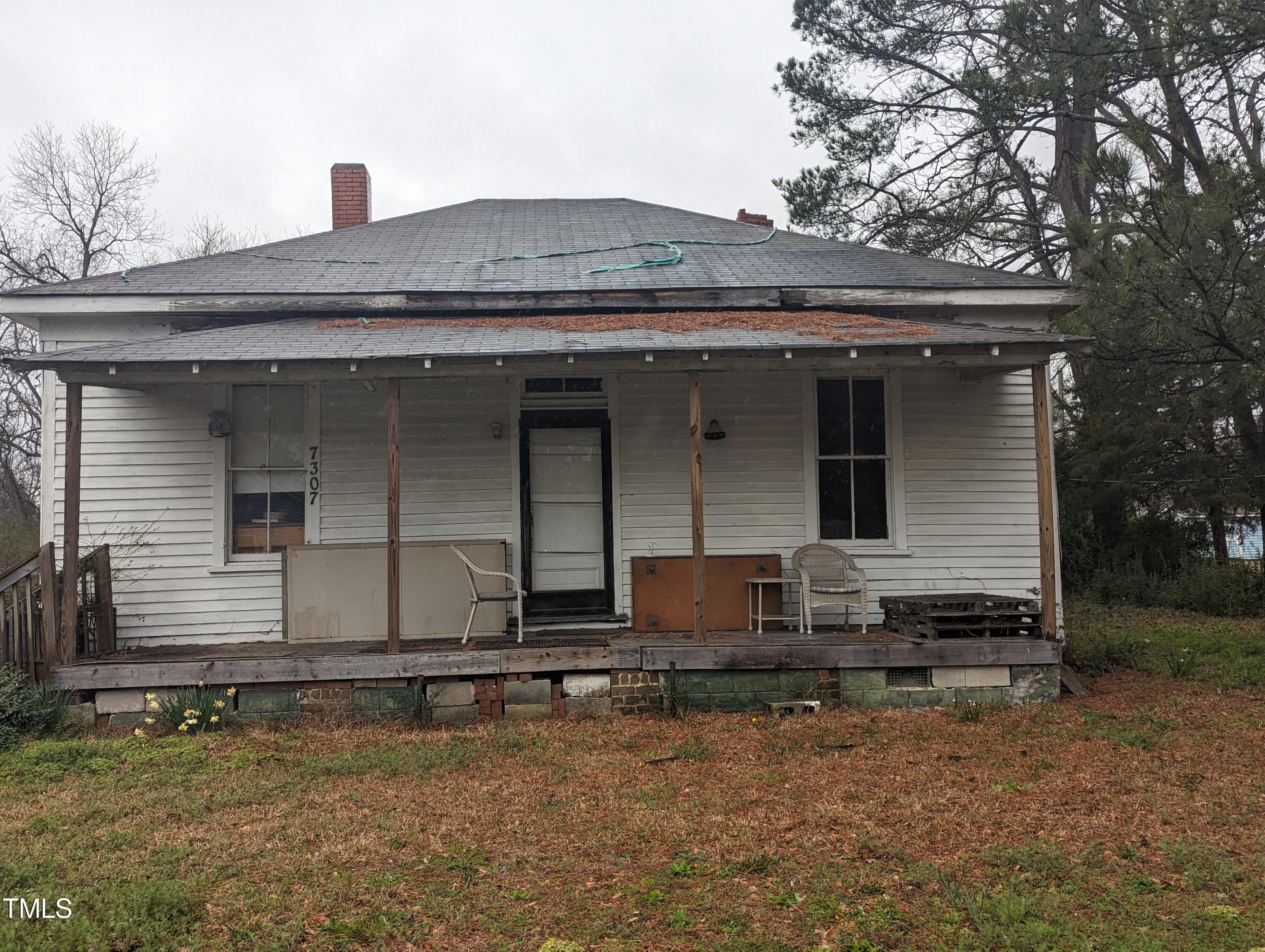 a front view of house with car parked