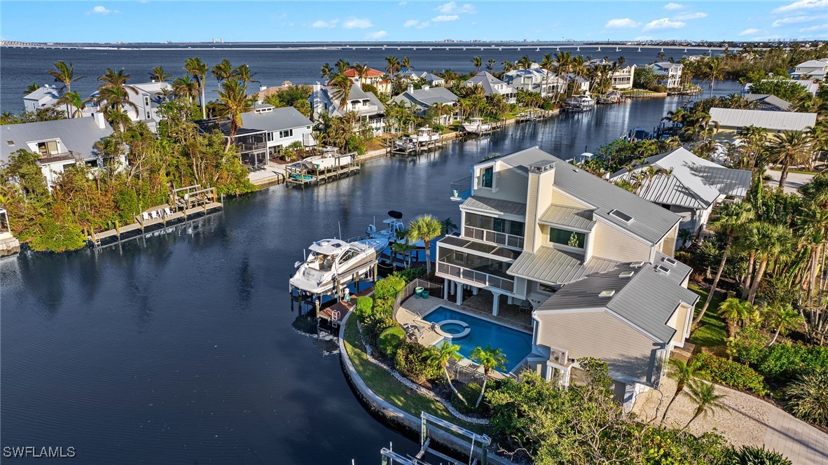 an aerial view of a house with outdoor seating