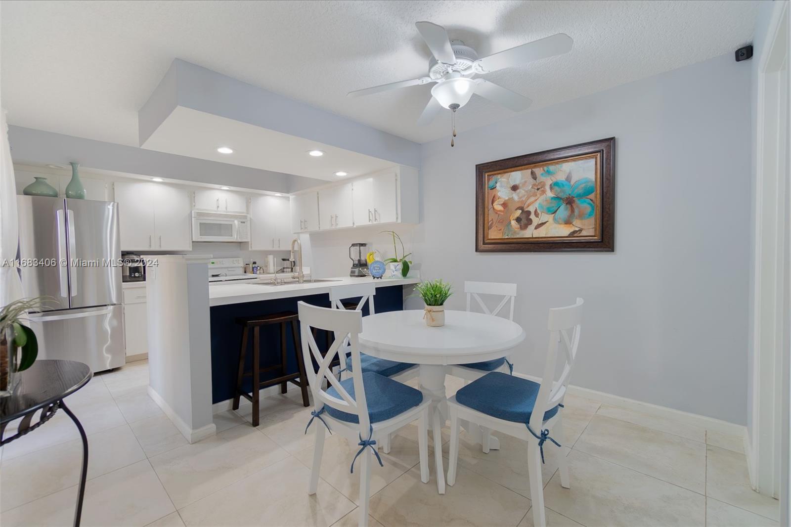 a view of kitchen with cabinets and chairs