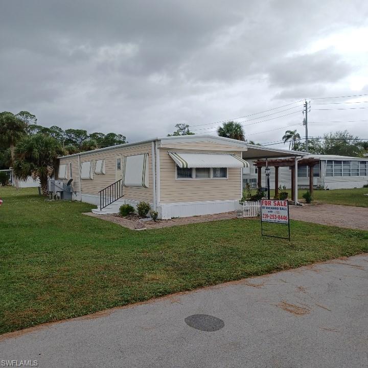 a view of a house with a backyard