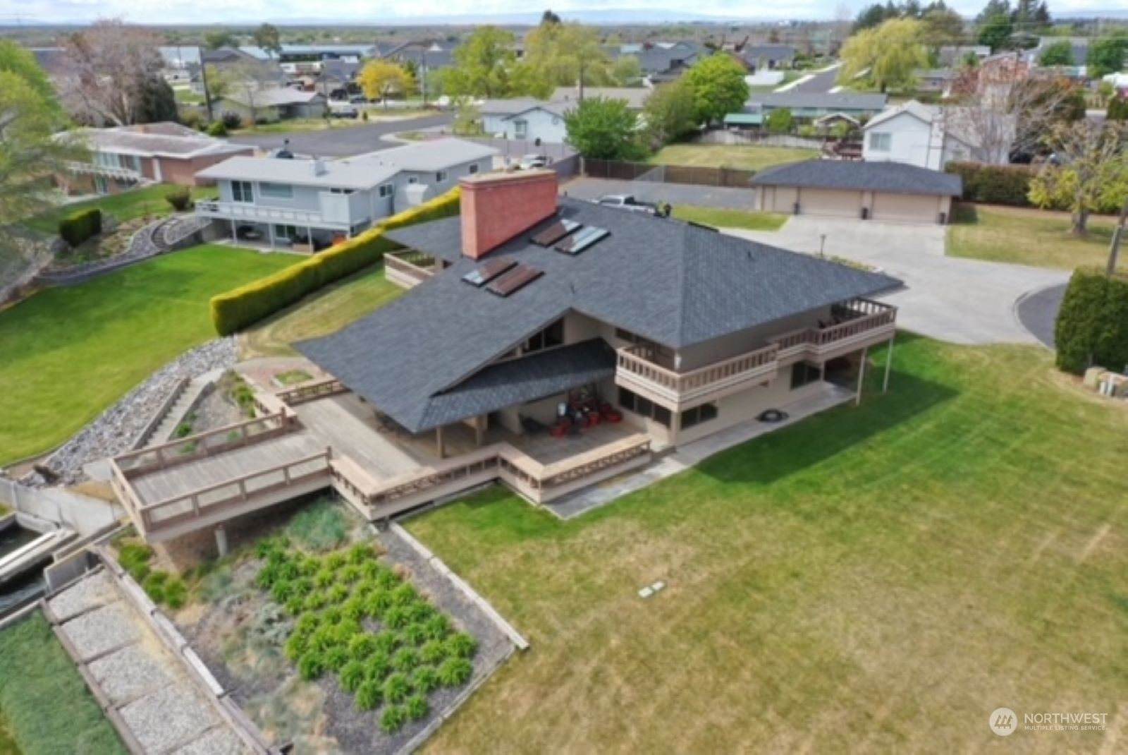 an aerial view of residential house with outdoor space and swimming pool