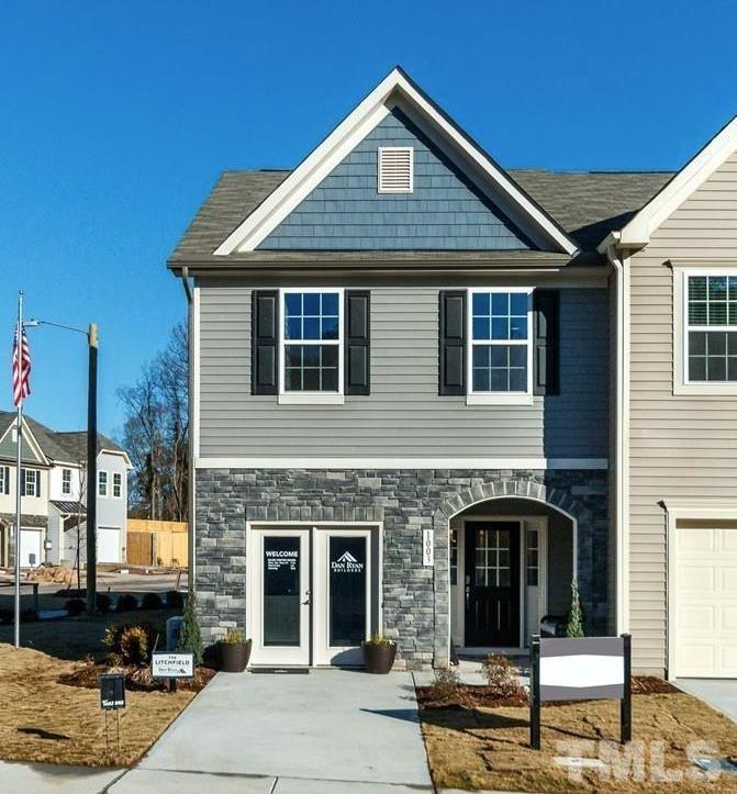 a front view of a house with garage