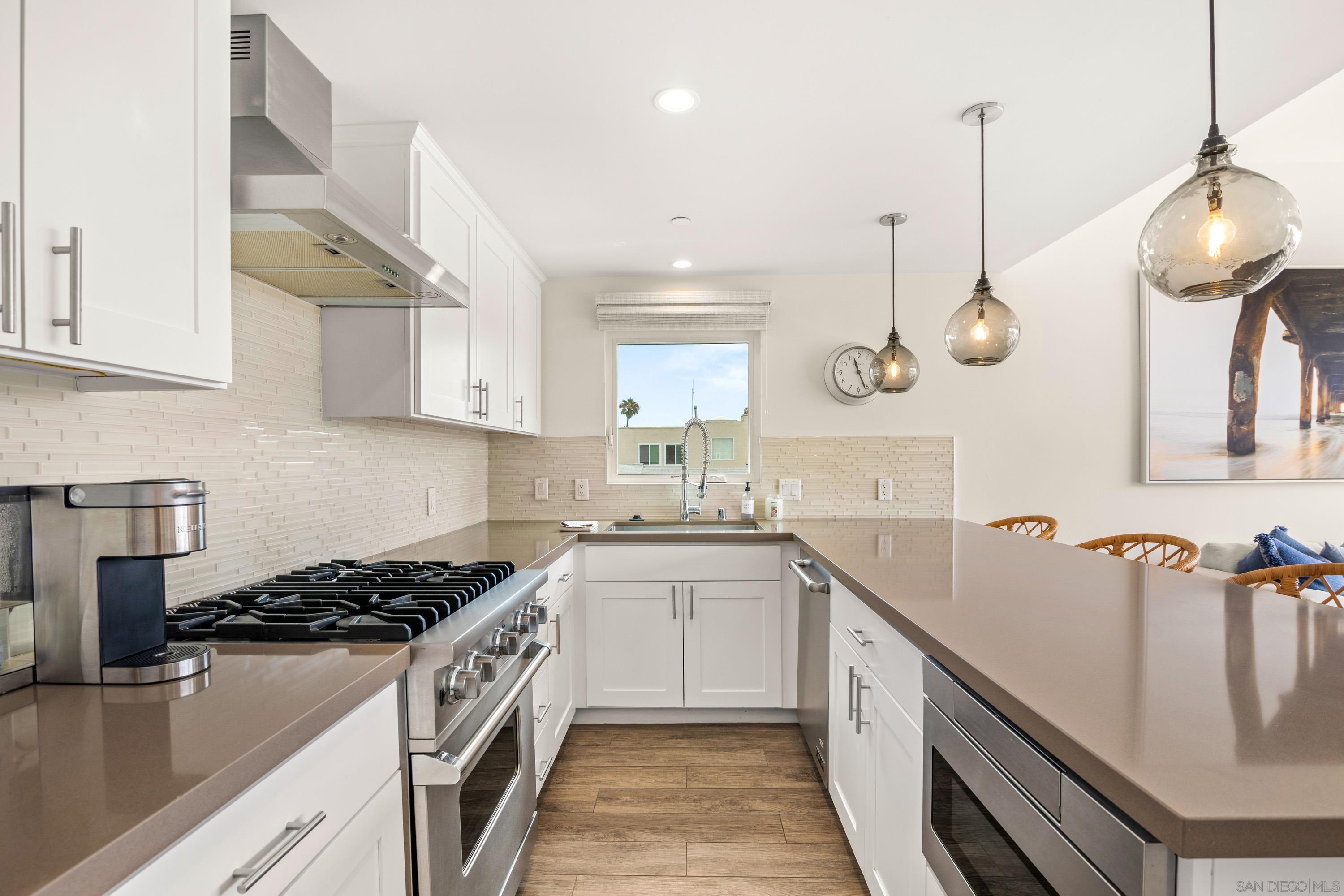 a kitchen with a sink stove and cabinets