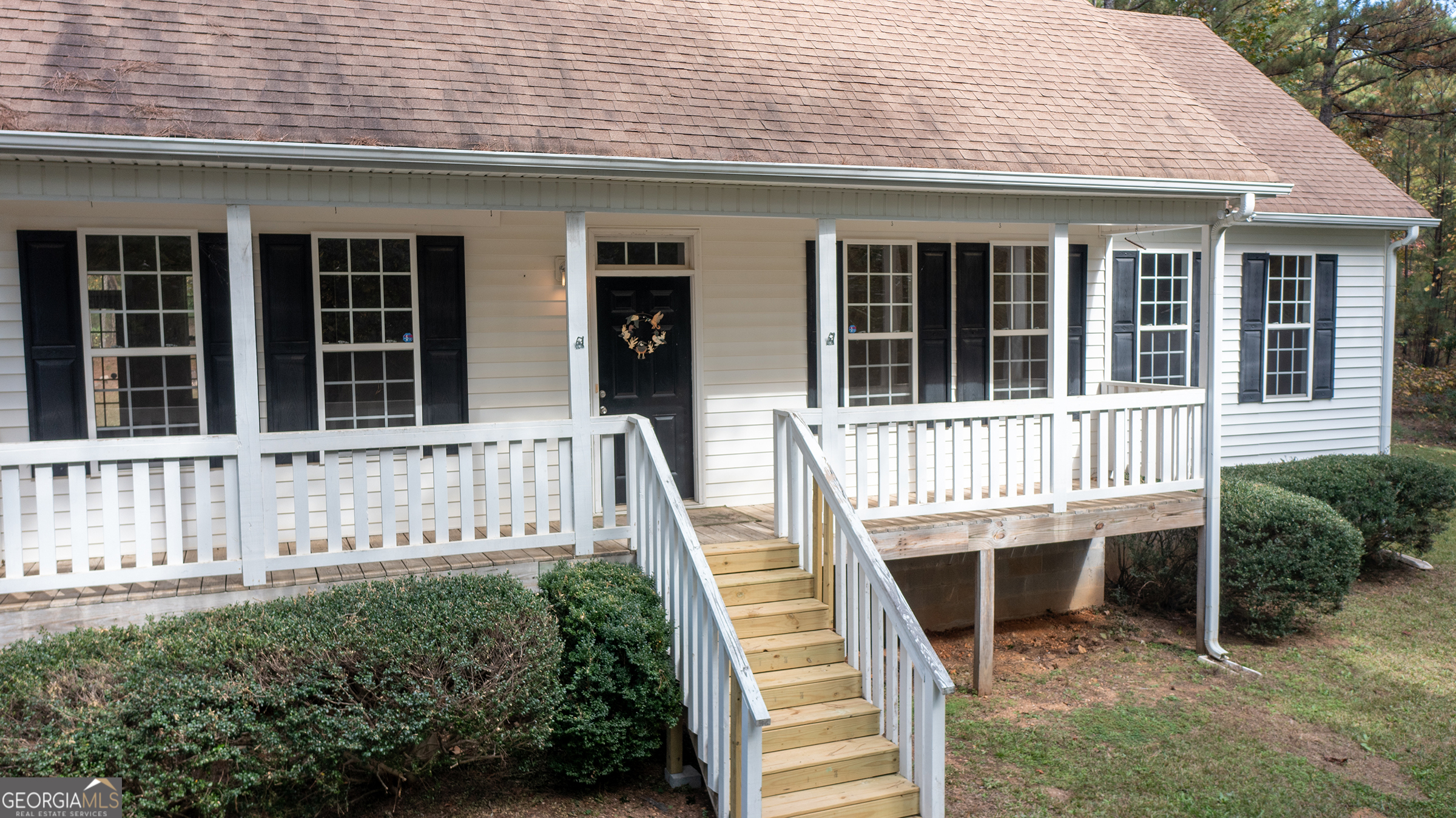 front view of a house with a small deck