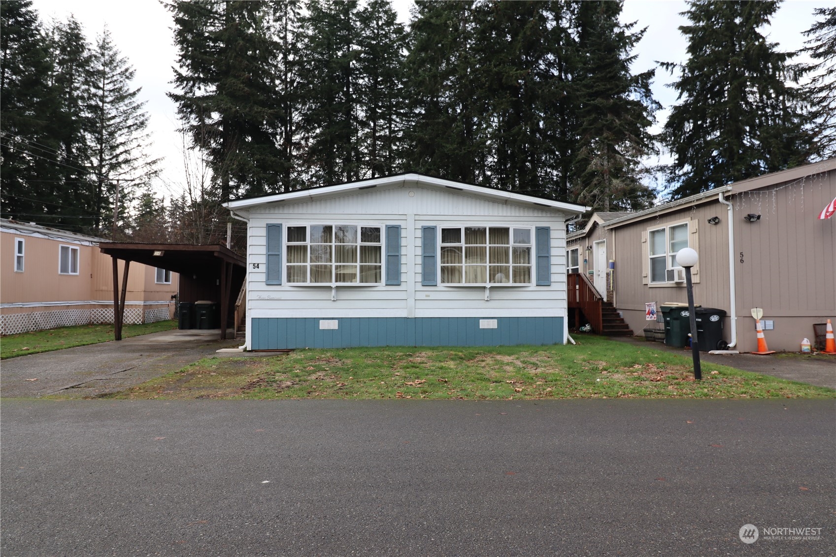 a view of a house with a yard and large tree