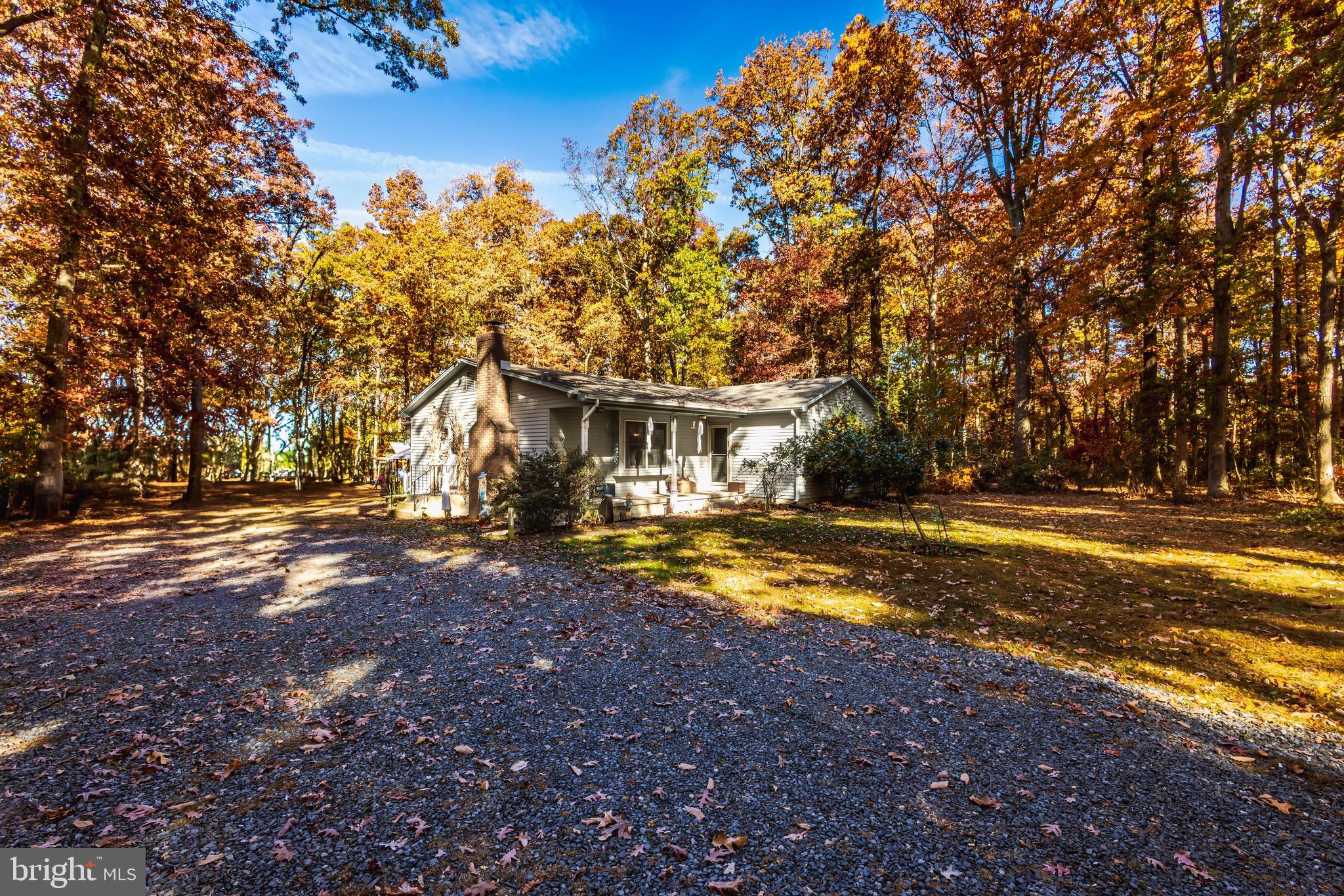 a view of house with outdoor space and sitting area