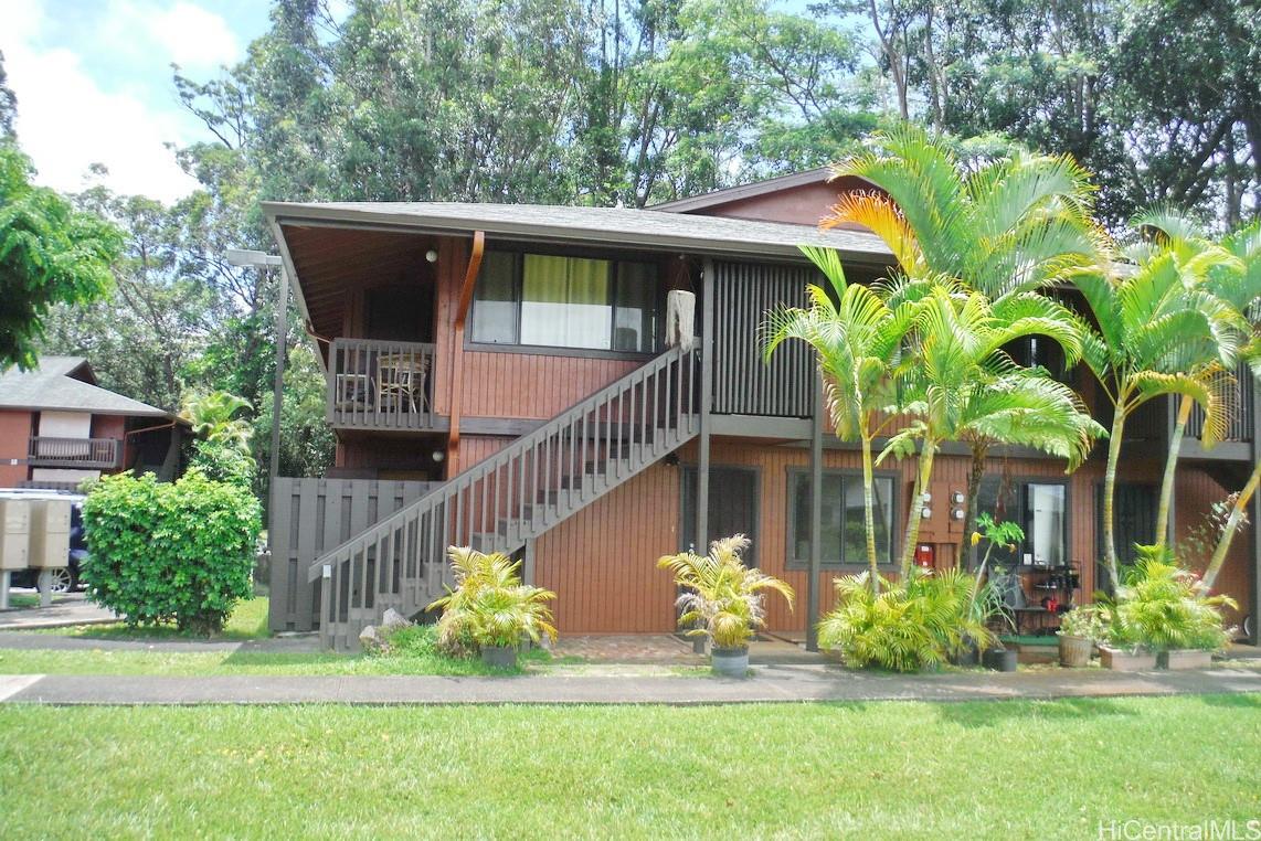 a front view of a house with a yard table and chairs