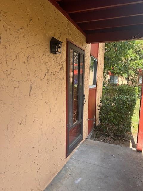 a view of a front door and wooden door