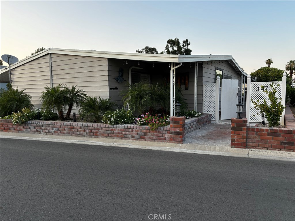 a view of a house with a porch and furniture