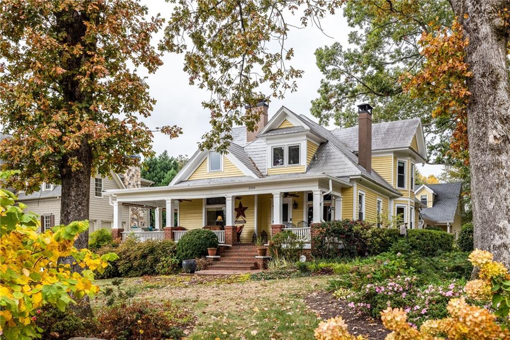 a front view of a house with yard porch and sitting area