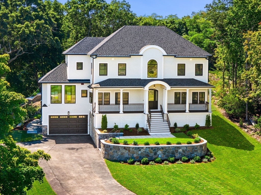 a front view of a house with a garden and swimming pool