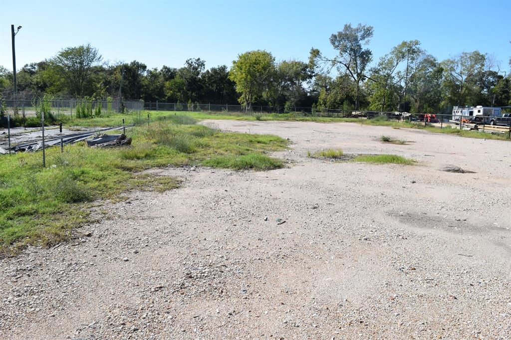 a view of a dirt road with a building in the background