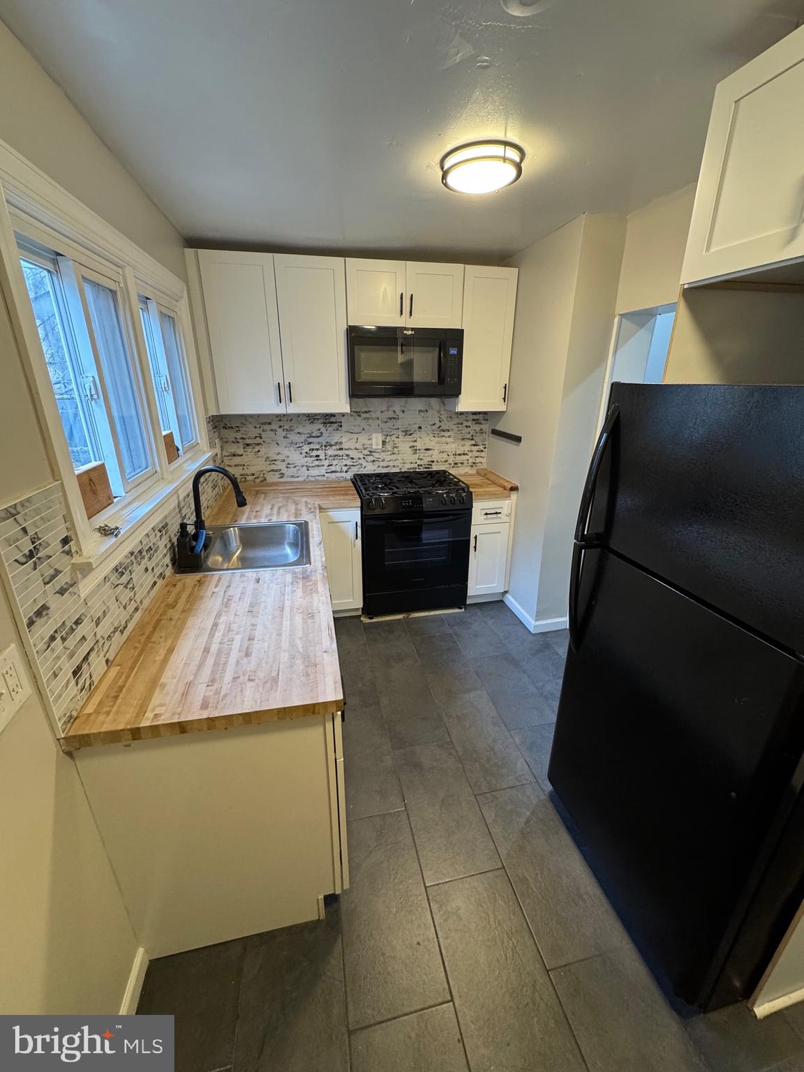 a kitchen with granite countertop a stove and a sink