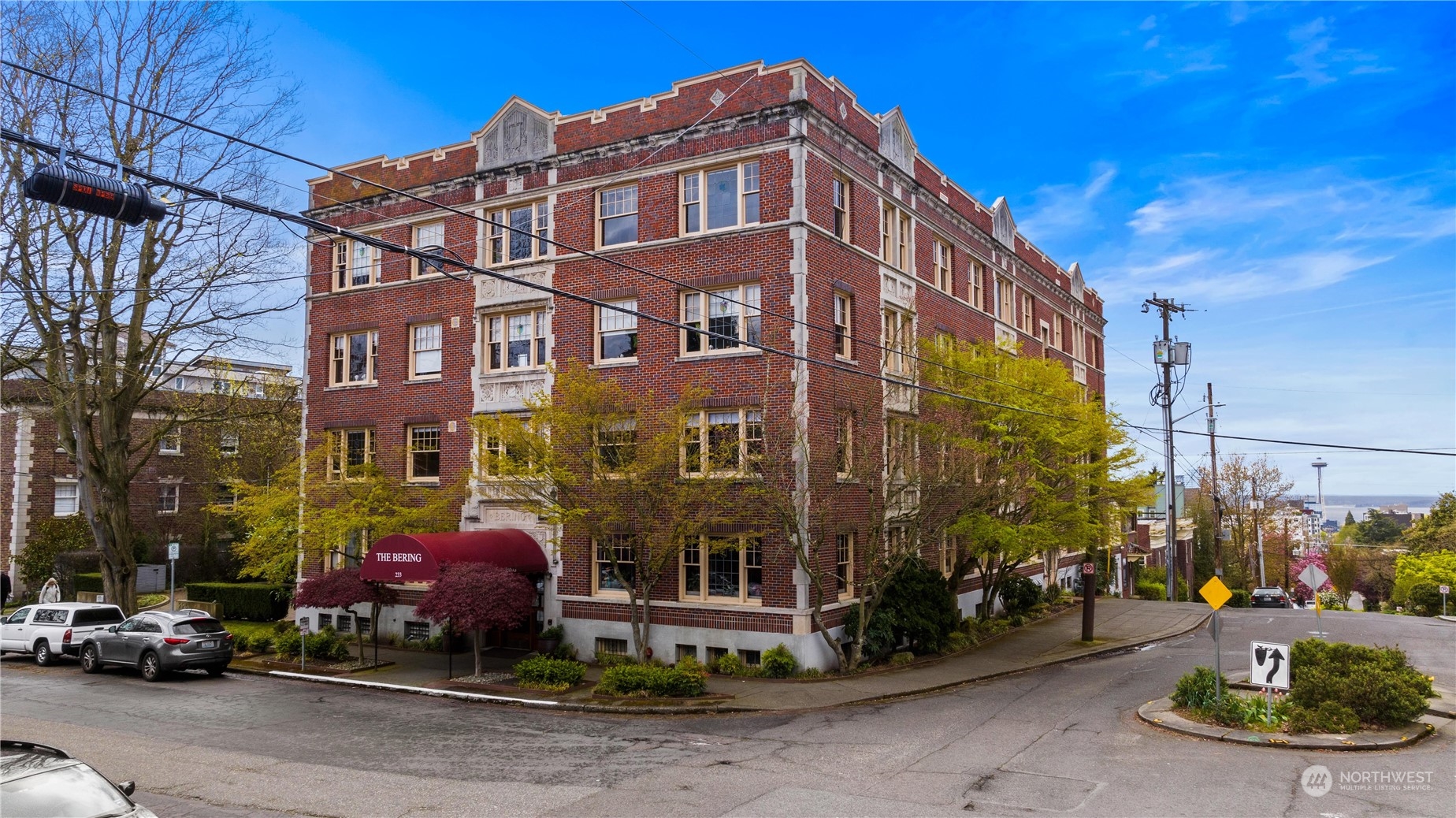 a front view of a building with parked cars