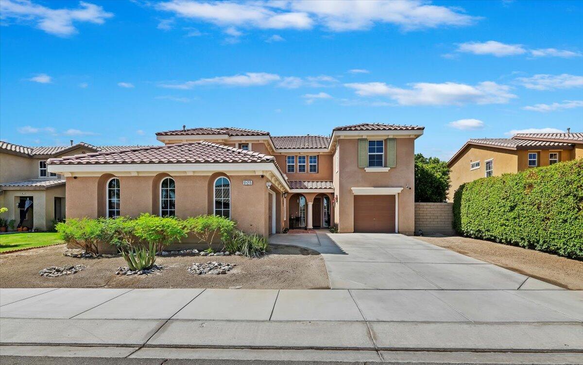 a front view of a house with a yard and garage