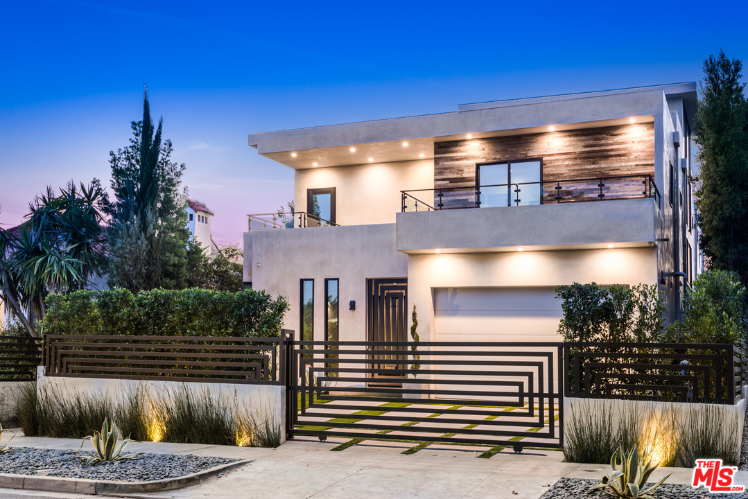 a view of a house with a patio and a yard