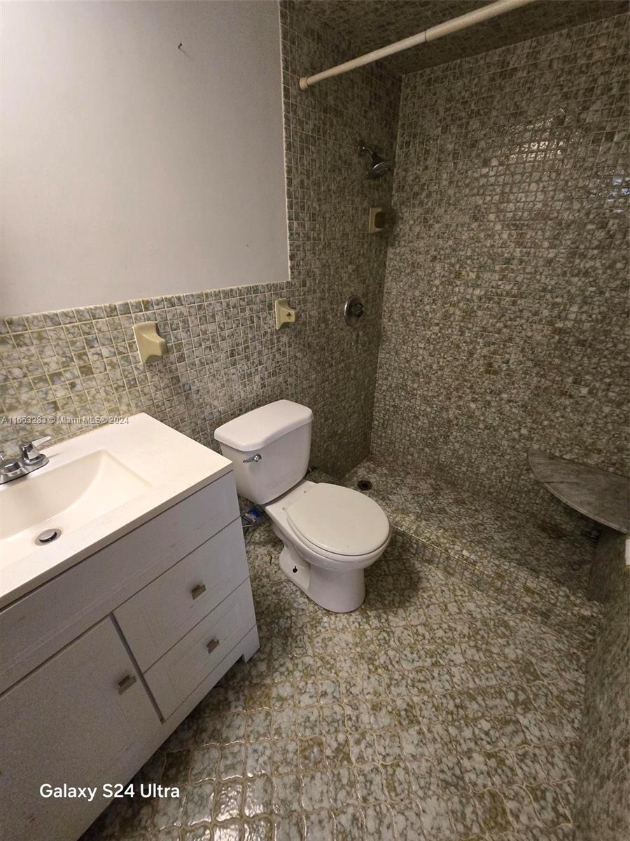 a bathroom with a toilet a sink and shower