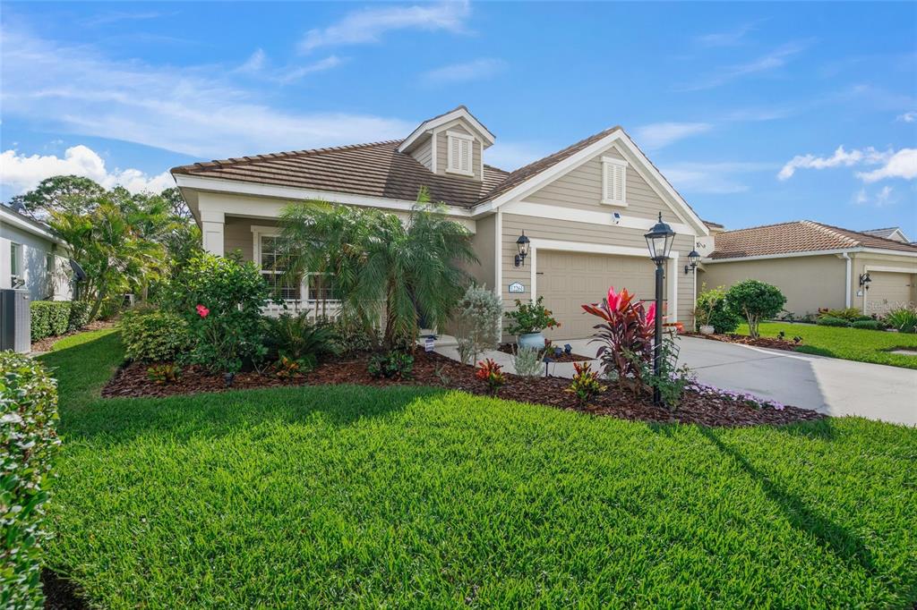 a front view of a house with a garden