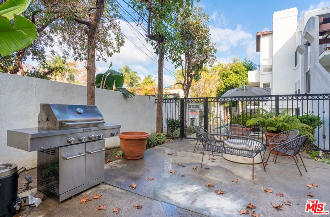 a backyard of a house with outdoor seating