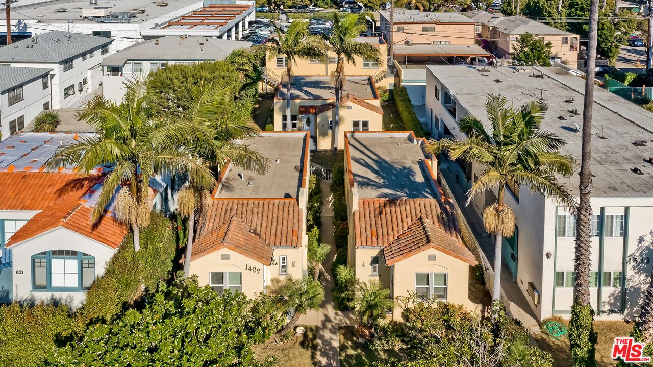 an aerial view of a residential apartment building with a yard