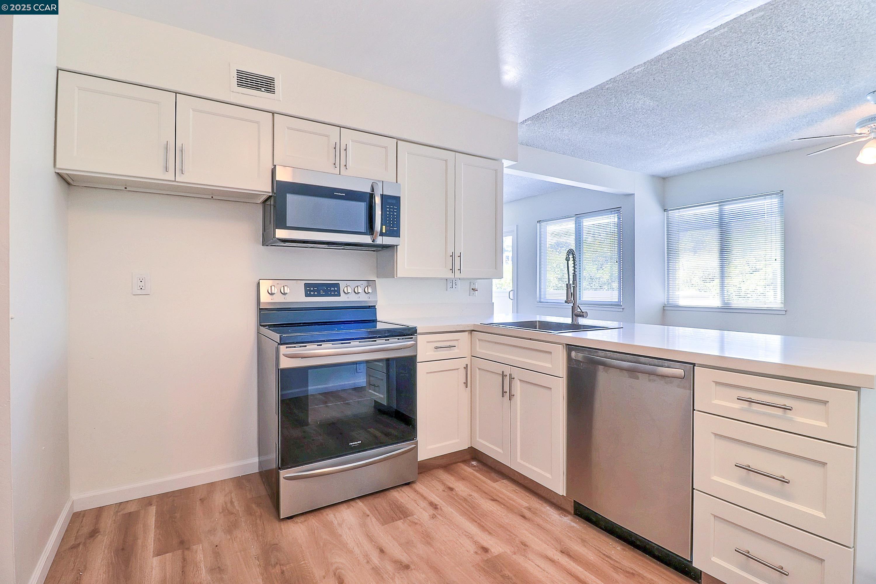 a kitchen with stainless steel appliances granite countertop a stove and a sink