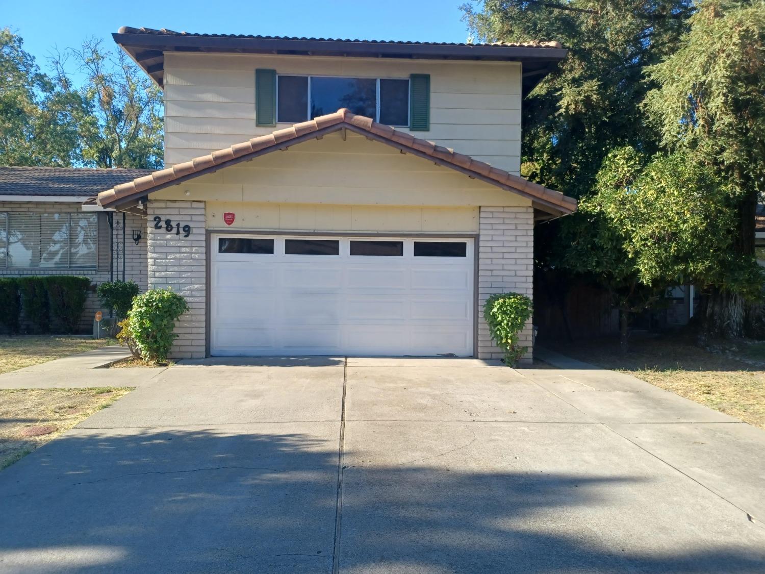 a front view of house with yard and trees