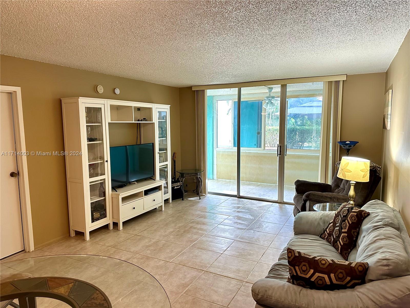 a living room with furniture gym equipment and a flat screen tv