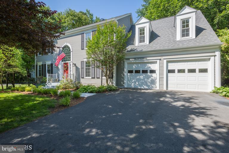 a front view of a house with a yard and a garage