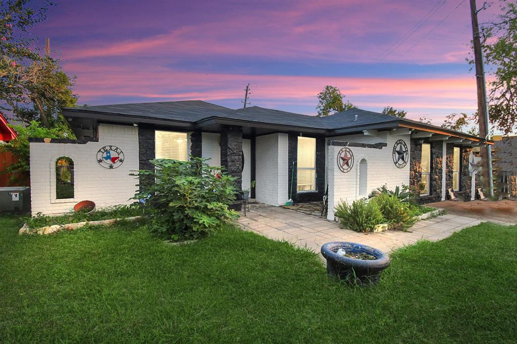 a front view of house with yard seating and green space