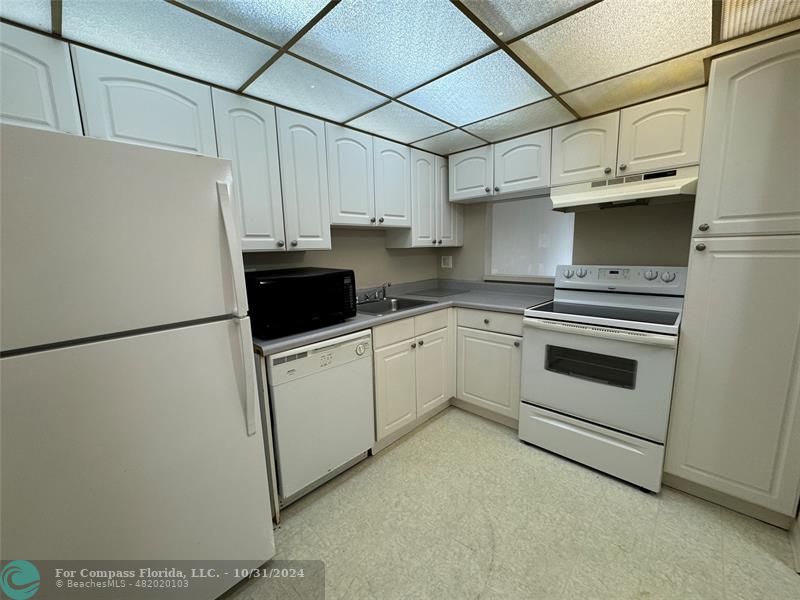 a white refrigerator freezer sitting inside of a kitchen