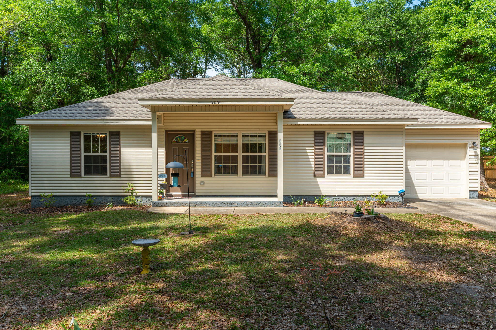 a front view of a house with a garden